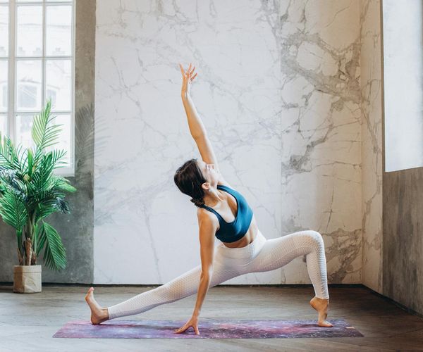 A person performing a flexibility-focused yoga stretch.